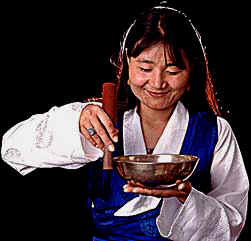 Yeko playing a 16th century LWTL 7 5/8" Tibetan singing bowl around the rim