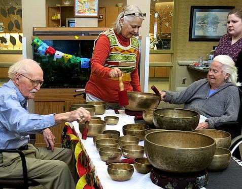 Facility residents enjoying Nancy's Tibetan singing bowls.